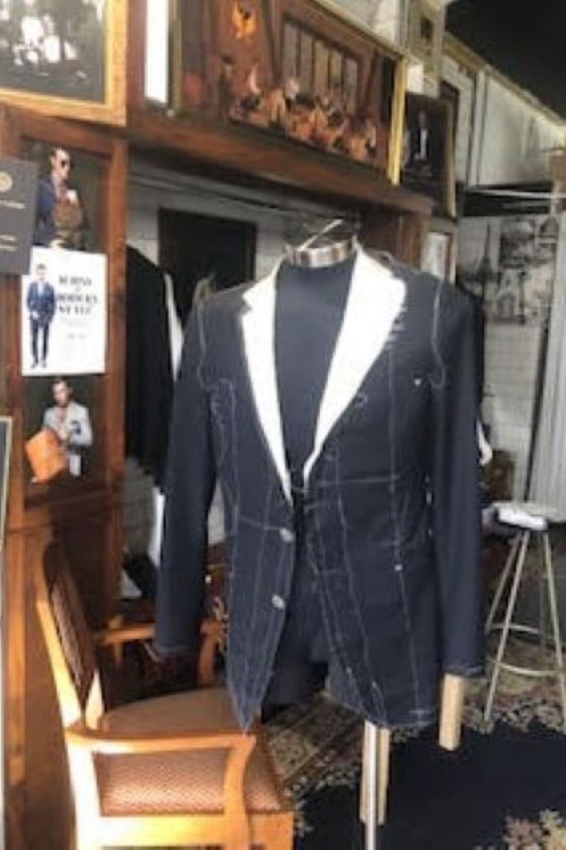 Close-up of a bespoke suit jacket interior showing the raw, hand-stitched floating canvas construction inside the workshop of West End Tailor in Brisbane.