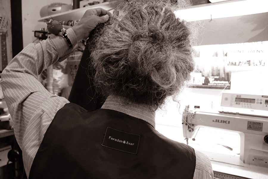 Tailor working on a sewing machine inside a Brisbane tailoring studio
