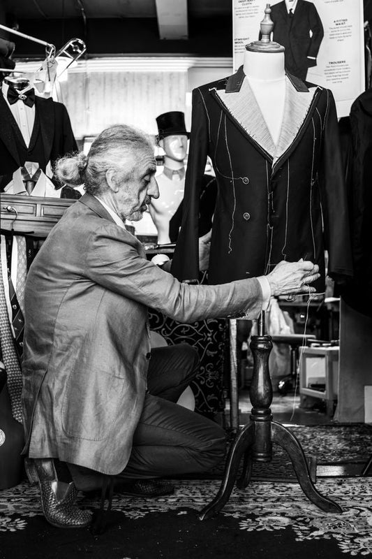 Master tailor fitting a custom wool wedding suit at West End Tailor studio in Brisbane.