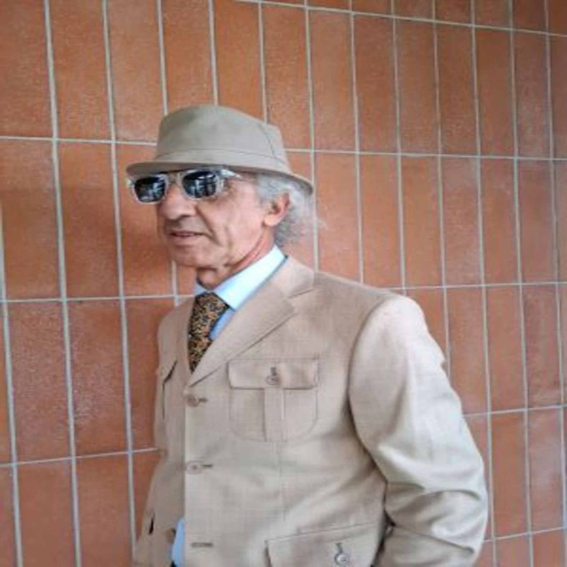 Angled view of man wearing beige safari suit jacket model 3190 – West End Tailor, Brisbane