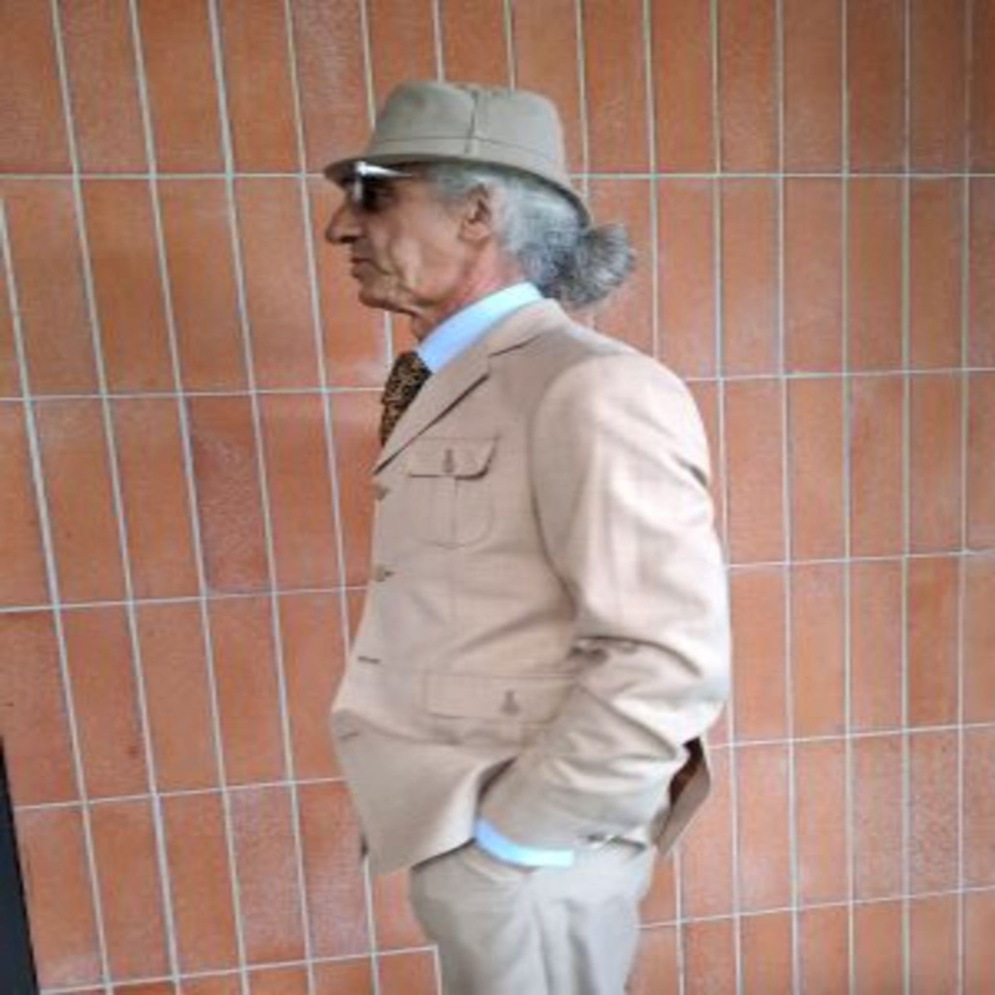 Side view of man wearing beige safari suit jacket model 3190 – West End Tailor, Brisbane